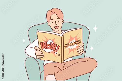 Man with smile on face reads comics about superheroes saving world, sitting in chair