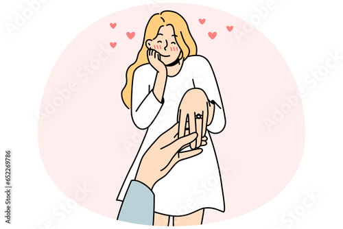 Happy young woman with ring on finger is engaged. Man holding female lover hand make marriage proposal. Ove and relationship. Vector illustration.