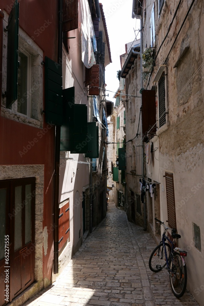 Vertical shot of a narrow street with buildings