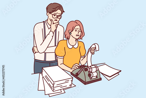 Retail business employees are changing cash tape into check issuing equipment, and are experiencing problems due to outdated cash machine. Man and woman doing financial audit in company