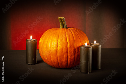 Pumpkin and candles on a dark background. Halloween concept.