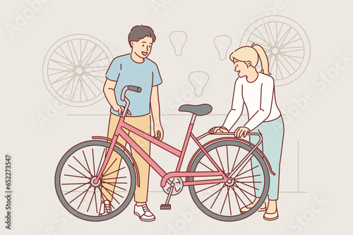 Woman cyclist came to workshop to repair or tune bicycle and buy additional accessories for hobby