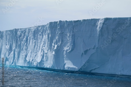 a giant glacier in a big body of water that has been turned into an ice © Clélia Van Heijst/Wirestock Creators