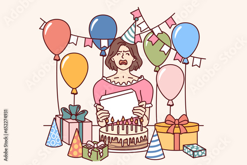 Frustrated woman stands in middle of birthday gifts and balloons, crying and hysterical due to aging. Girl made scandal at birthday party with disliked giftboxes or offensive wishes