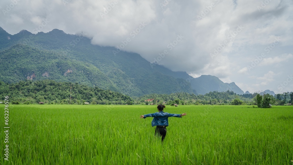 Beautiful view of a female enjoying the view in the rice field in Lao