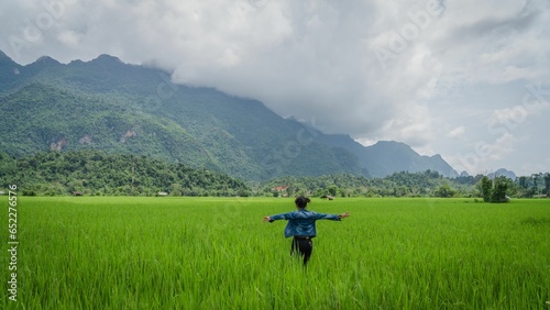 Beautiful view of a female enjoying the view in the rice field in Lao