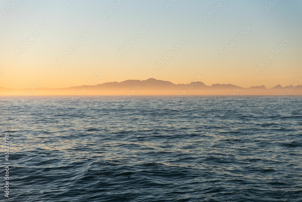 Scenic view of sea waves at sunset