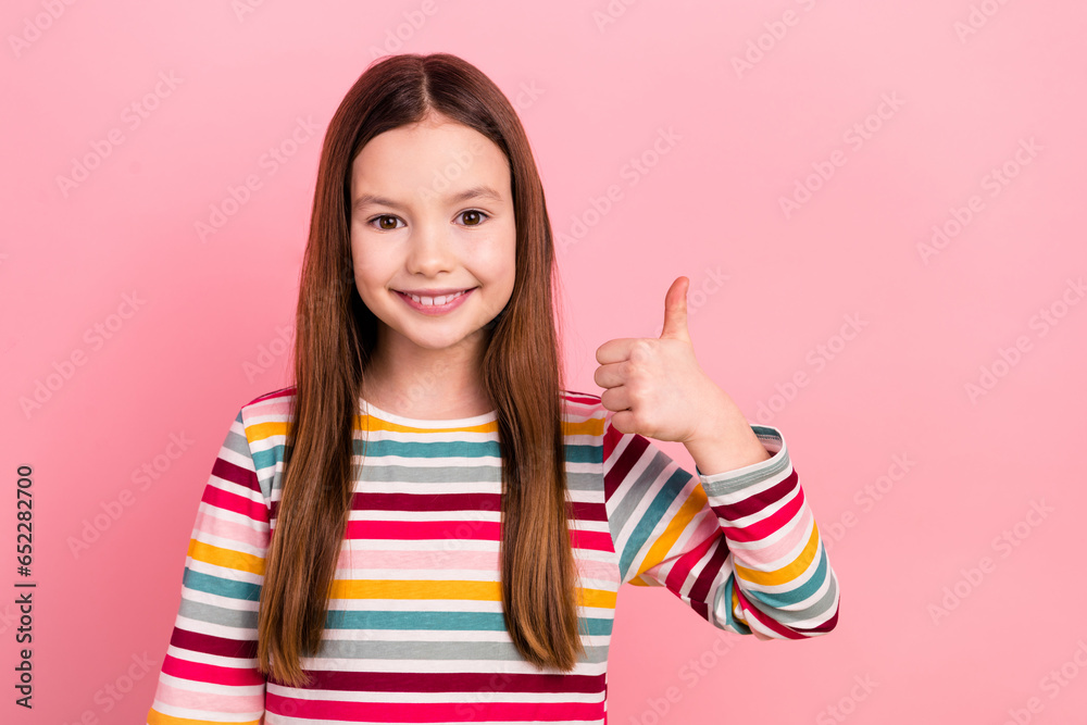 Photo of funny brown hair positive school kid girl gesture thumb up advert promoting entertainment center isolated on pink color background Photo of funny brown hair positive school kid girl gesture thumb up advert promoting entertainment center isolated on pink color background