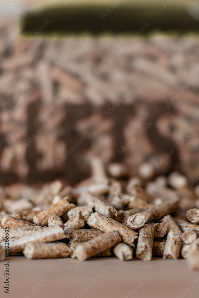 Pile of pellets with bag of granules in the background Pile of pellets with bag of granules in the background