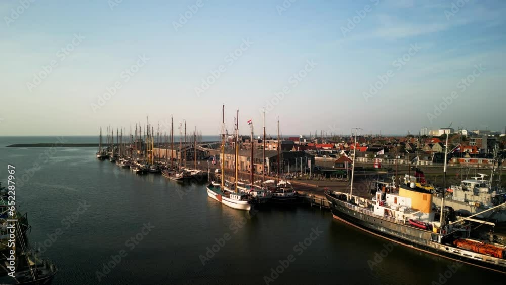 Aerial view of water in Harlingen Bay, boats, houses by the canal, villages on the North Sea with a yacht harbor, summer holidays in the Netherlands Aerial view of water in Harlingen Bay, boats, houses by the canal, villages on the North Sea with a yacht harbor, summer holidays in the Netherlands