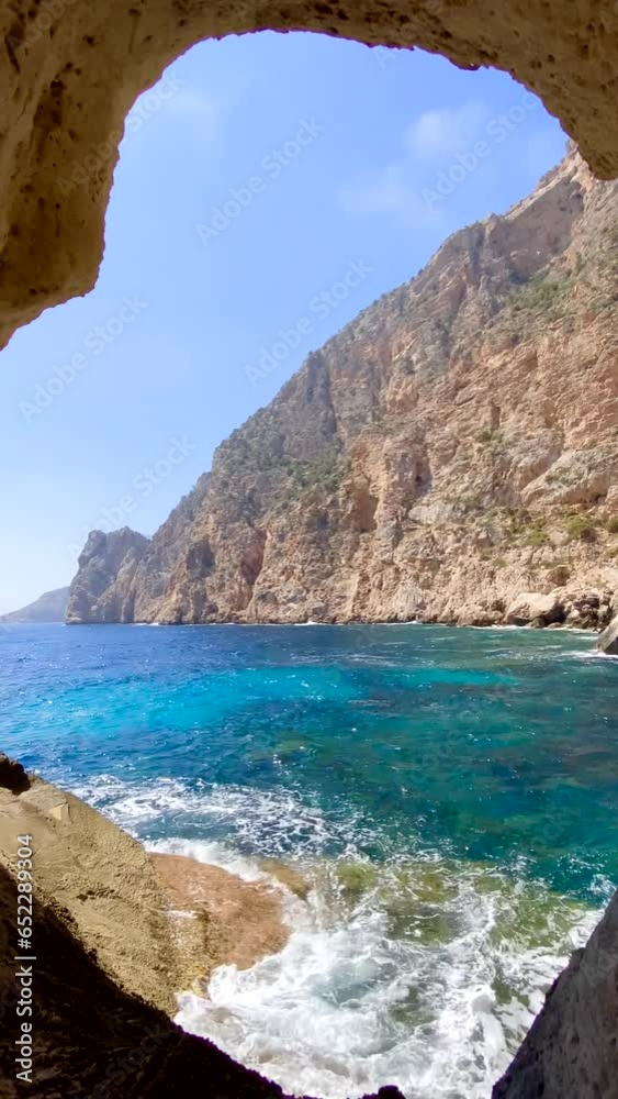 Marine cave on Es Vedra Island on the seaboard island of Ibiza, Spain, vertical shot