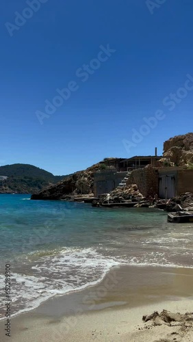 Fisherman's house on the beach of Benirras on the island of Ibiza, Spain, vertical shot photo