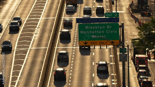 New York, USA - 3 September 2023: Rush hour traffic in Manhattan, view from the bridge to East River Greenway highway speed road across the city. 4k transportation video in America. photo