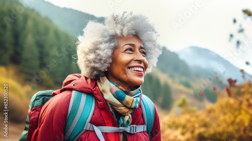 Healthy retirement lifestyle. Portrait of an elderly African American woman in the forest. Joyful beautiful retired woman traveling through the forest. Generated by AI
