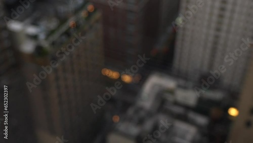Rainy day in New York city. 4k close up video with selective focus on rain water drops on window and the skyscrapers under clouds in background.