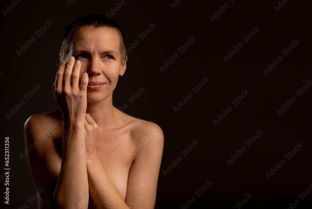 Nude middle-aged woman with short hair on a black background dot space for text .banner Nude middle-aged woman with short hair on a black background dot space for text .banner