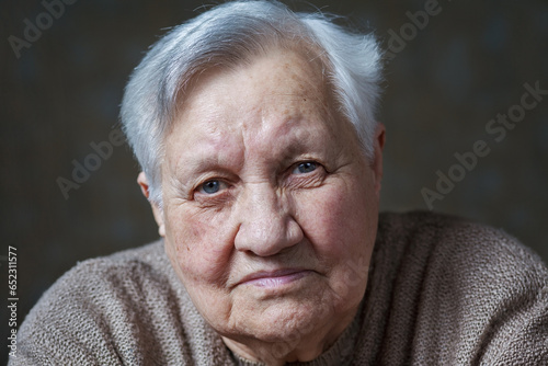 Elderly woman in the studio, close-up