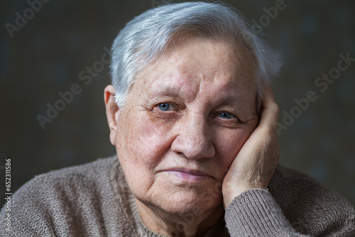 Elderly woman in the studio, close-up