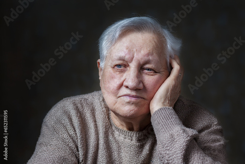 Elderly woman in the studio, close-up