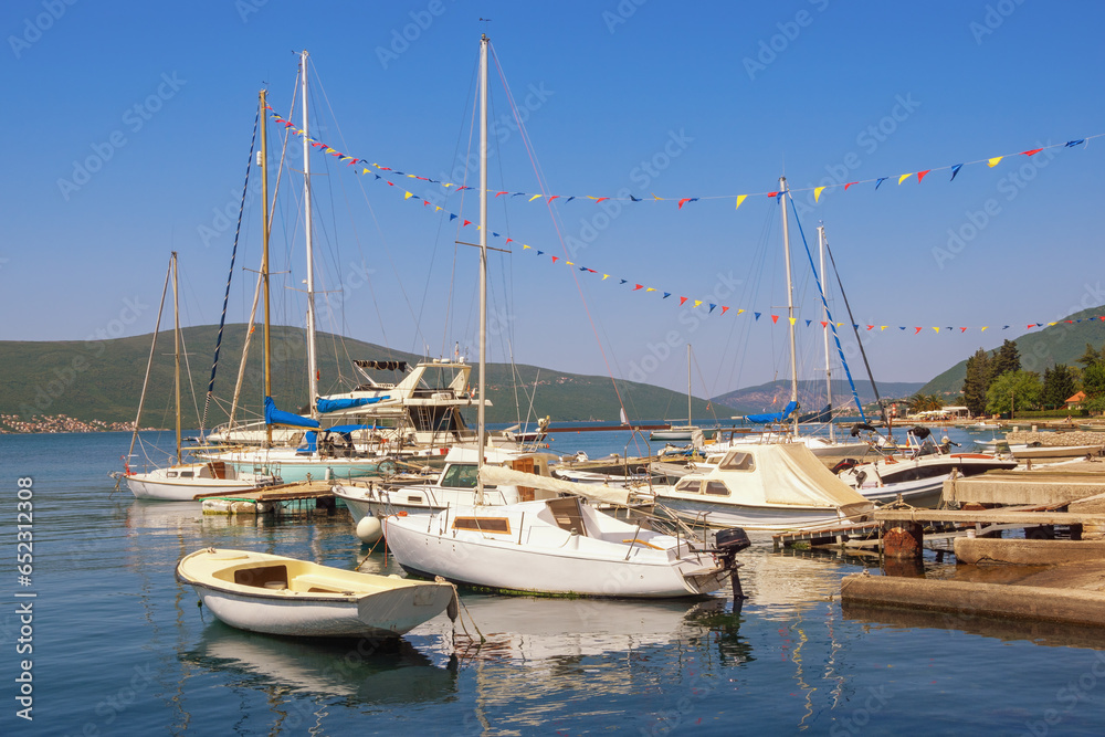 Beautiful  Mediterranean landscape. Sailboats and fishing boats on water. Montenegro, Adriatic Sea. View of Bay of Kotor near Tivat city