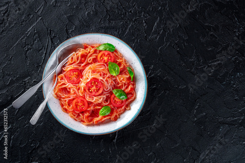 Konjac pasta. Shirataki noodles with tomato and basil, a healthy vegan dish, overhead flat lay shot with copy space