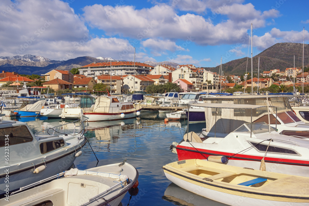 Beautiful Mediterranean landscape on sunny winter day. Fishing boats in harbor. Montenegro, Tivat city. View of Marina Kalimanj