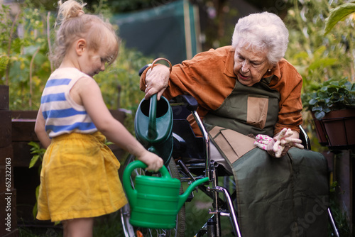Portrait of a little adorable girl helping her grandmother in the garden.