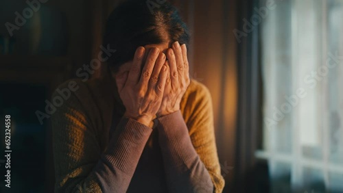 Depressed elderly woman crying, few coins and eviction notice on table, poverty