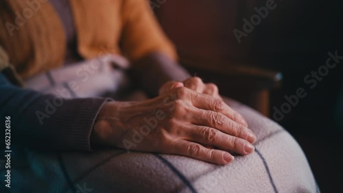 Trembling wrinkled hands close-up, lonely senior person covered with blanket photo