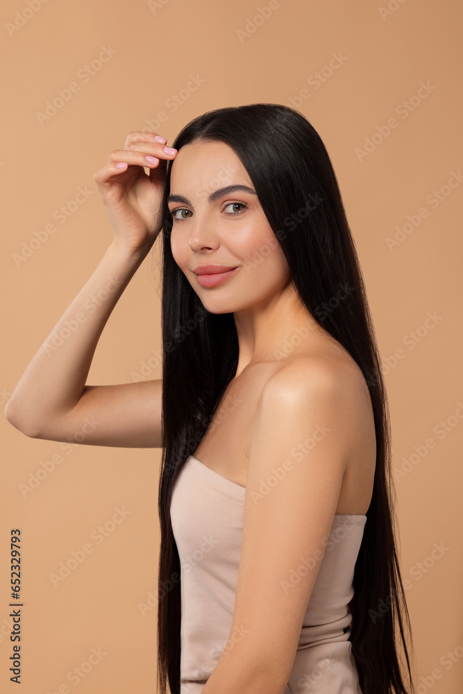 Beautiful woman with long hair on beige background Beautiful woman with long hair on beige background