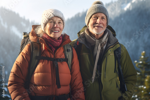 Mature man and woman hiking in the winter forest and mountains. Travel and active lifestyle of pensioners.