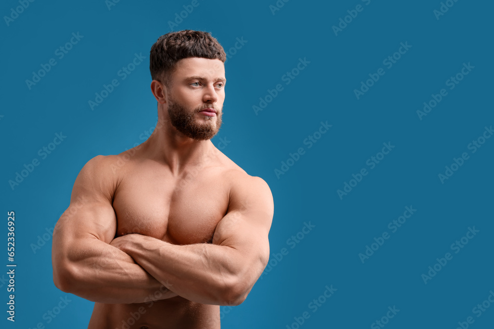 Fototapeta premium Handsome muscular man on light blue background, space for text. Sexy body