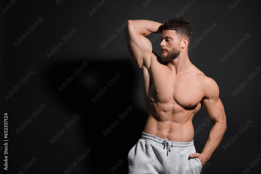 Fototapeta premium Handsome muscular man on black background, space for text. Sexy body