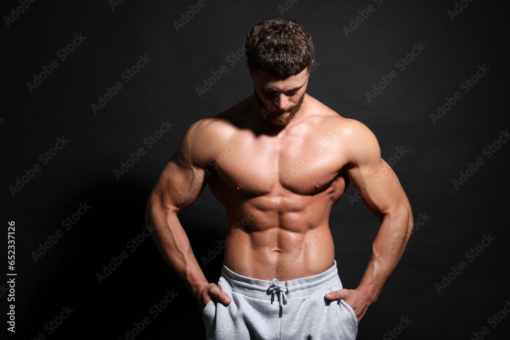 Fototapeta premium Handsome muscular man on black background. Sexy body
