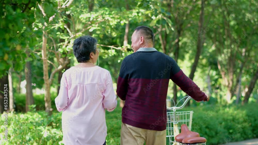 Happy and healthy couple Asian walking and push bicycle after workout. Enjoyment of active seniors, outdoor activity after retirement, health care insurance concept, Family and friendship lifestyle Happy and healthy couple Asian walking and push bicycle after workout. Enjoyment of active seniors, outdoor activity after retirement, health care insurance concept, Family and friendship lifestyle