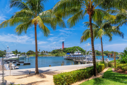 Fototapeta Naklejka Na Ścianę i Meble -  Jupiter lighthouse and harbor at sunny summer day and palm trees, West Palm Beach, Florida