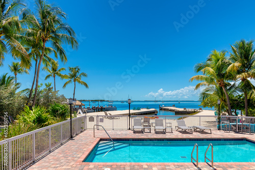 Palm trees and pool with beach loungers in tropical beach resort in tropical island, Key Largo. Florida © lucky-photo