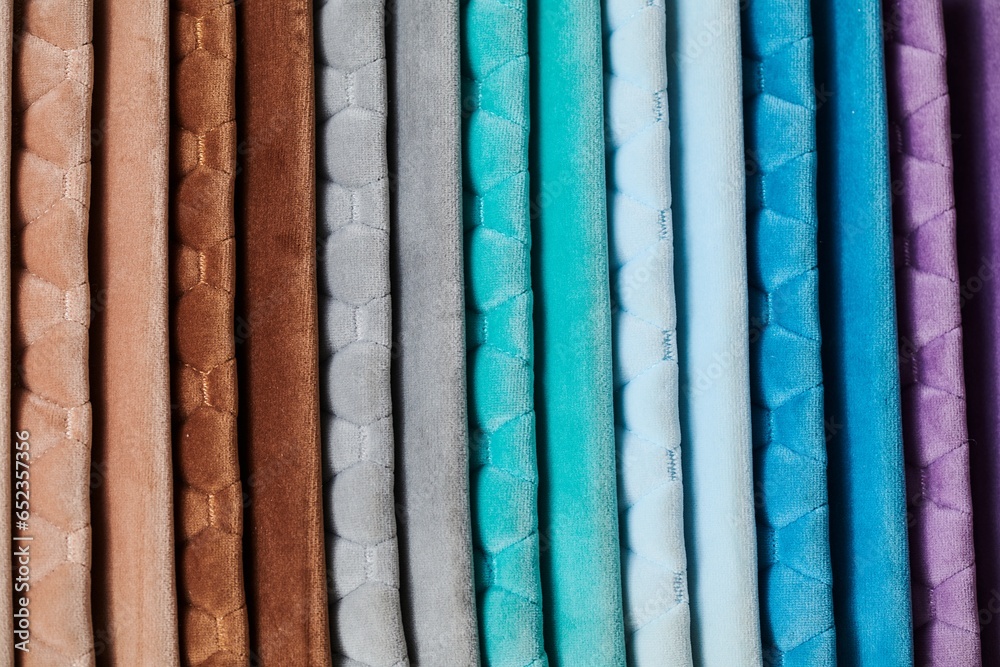 Colorful samples of upholstery fabrics close-up. Leather and suede for furniture renovation