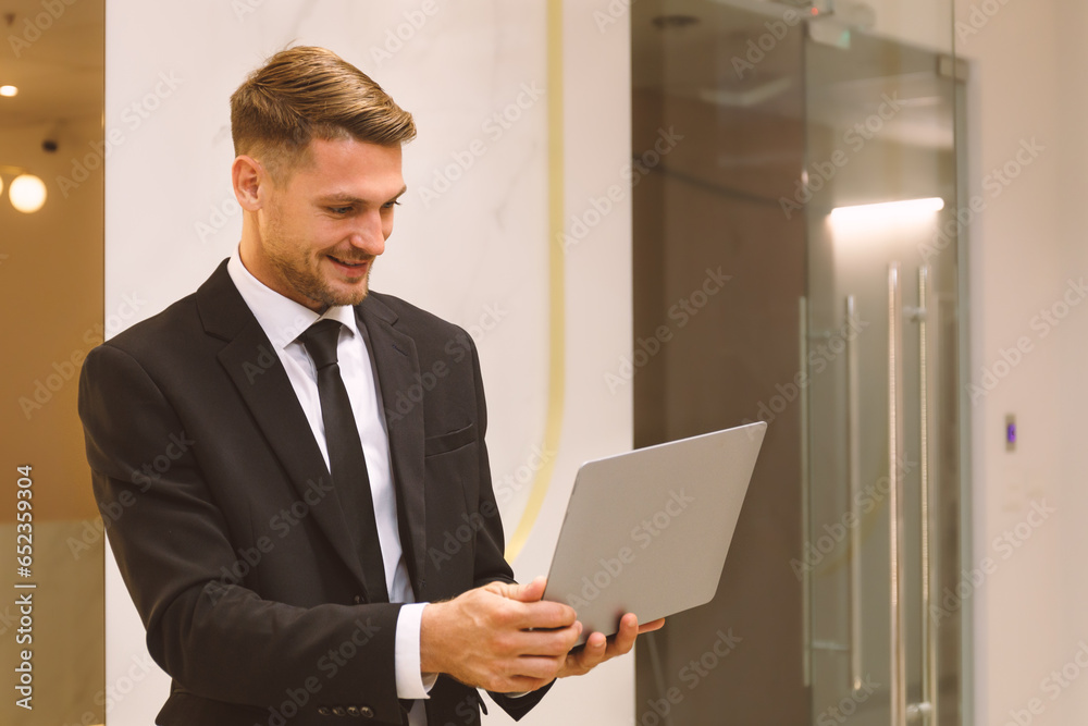 Portrait of a young businessman Laptop computers standing together in modern office Data analyst and creative designer