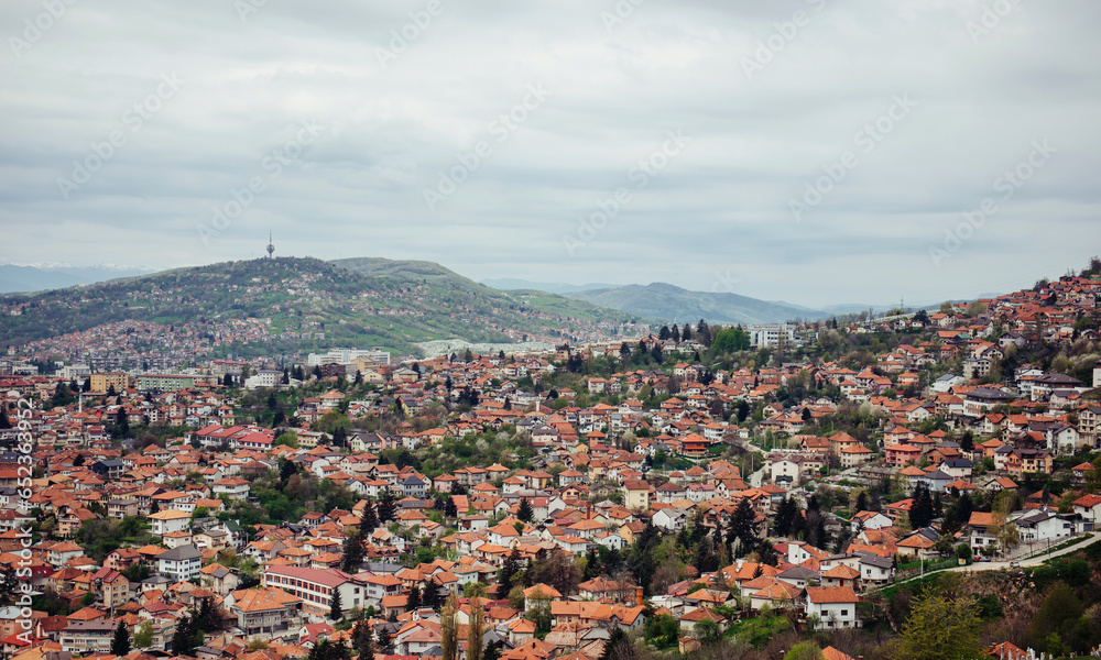 Panoramic view of the spring city of Sarajevo, Bosnia and Herzegovina. A trip to a European city in the mountains with orange roofs