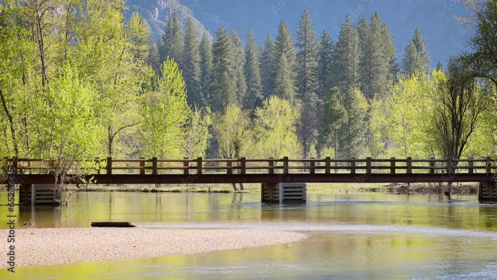 Swinging Bridge over the Merced River as it runs through Yosemite National Park in California. Swinging Bridge over the Merced River as it runs through Yosemite National Park in California.