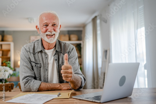 senior caucasian man open mail letter or document envelope at home