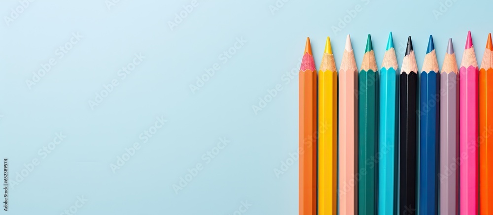 Fototapeta premium Colored pencils on isolated pastel background Copy space
