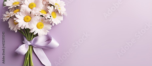 Postcard featuring a tied bouquet of daisies on a isolated pastel background Copy space