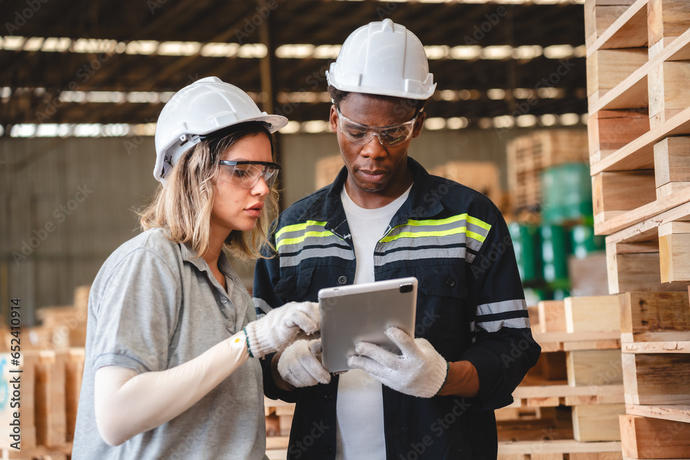 woman carpenter worker wearing safety uniform working to quality control checking of wooden products at workshop manufacturing. female technician making wooden in carpenter's shop industry warehouse.
