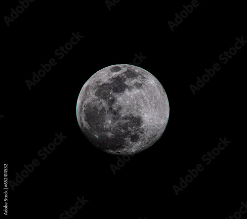 Detailed close up zoom photo of the full super blue moon with black background.