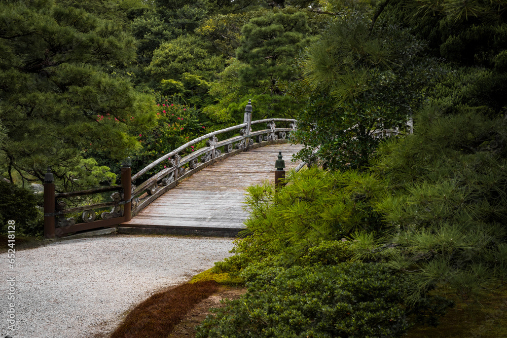 The entrance to a beautiful bridge spanning a pond on the castle grounds in Kyoto, Japan. The entrance to a beautiful bridge spanning a pond on the castle grounds in Kyoto, Japan.