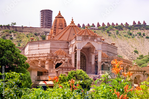 artistic red stone jain temple at morning from unique angle photo