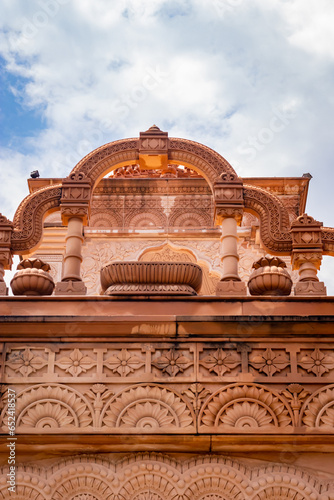 artistic red stone jain temple at morning from unique angle photo