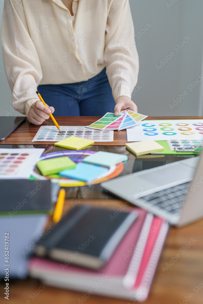 Creative idea Business female Artist Creative Designer sketch graphic drawing on graphic tablet and Color swatch samples Concept of idea creativity. Creative idea Business female Artist Creative Designer sketch graphic drawing on graphic tablet and Color swatch samples Concept of idea creativity.